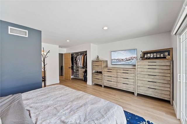 bedroom with visible vents, recessed lighting, a closet, and wood finished floors
