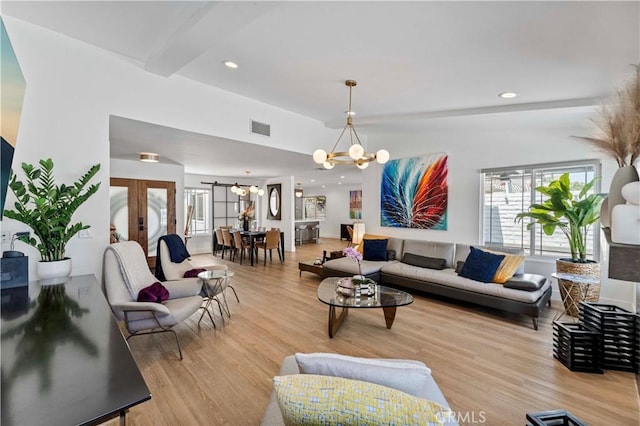 living room featuring visible vents, recessed lighting, a chandelier, and wood finished floors