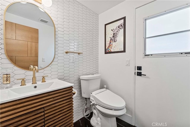 7520 Bobbyboyar Ave, West Hills, CA 91304 - half bathroom with vanity, toilet, decorative backsplash, and tile walls