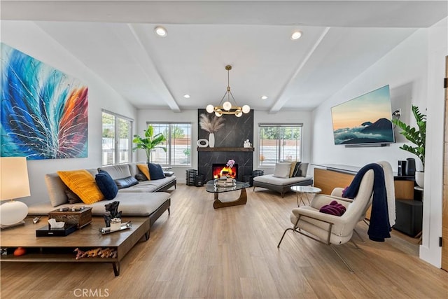 living area featuring wood finished floors, a high end fireplace, and vaulted ceiling with beams