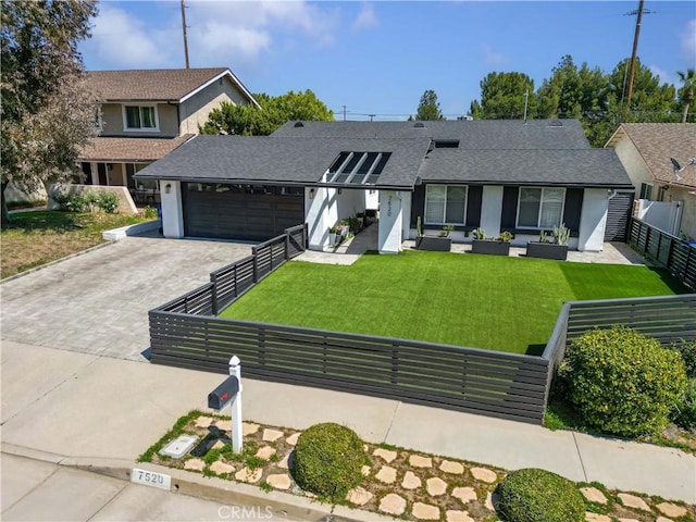 view of front facade featuring a garage, fence, a front lawn, decorative driveway, and roof with shingles