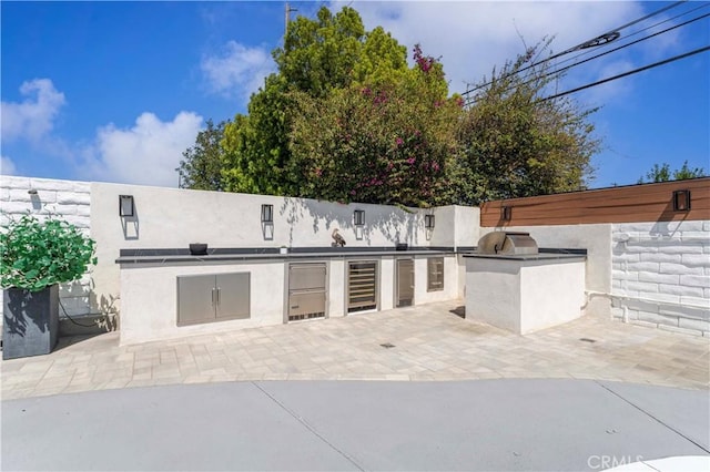 view of patio featuring exterior kitchen and area for grilling