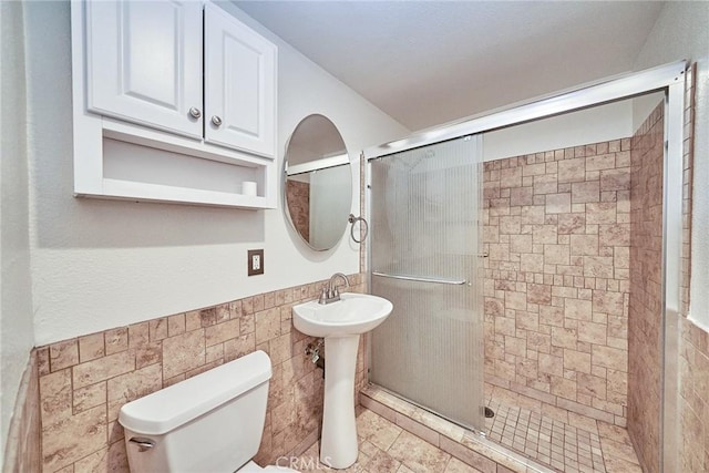19910 Cantara St, Winnetka, CA 91306 - bathroom featuring toilet, tile walls, wainscoting, and a stall shower