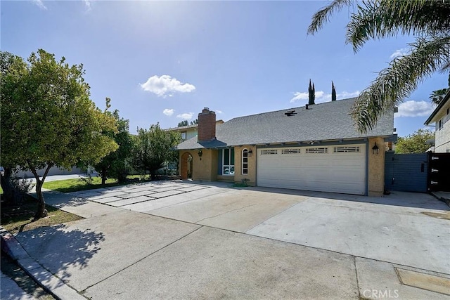19910 Cantara St, Winnetka, CA 91306 - view of front of home with a garage, a chimney, driveway, and stucco siding