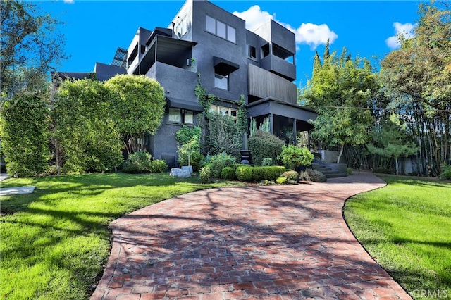 view of property's community with a lawn