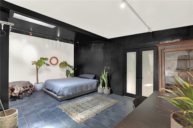 tiled bedroom with track lighting and french doors
