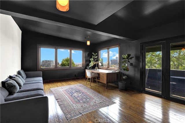 living area featuring vaulted ceiling and wood finished floors