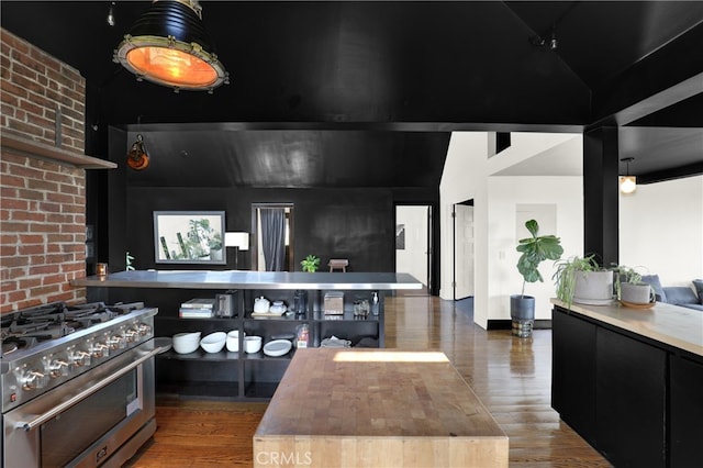 801 E Edgeware Rd, Los Angeles, CA 90026 - kitchen featuring high end stainless steel range, dark cabinets, wood finished floors, wooden counters, and high vaulted ceiling