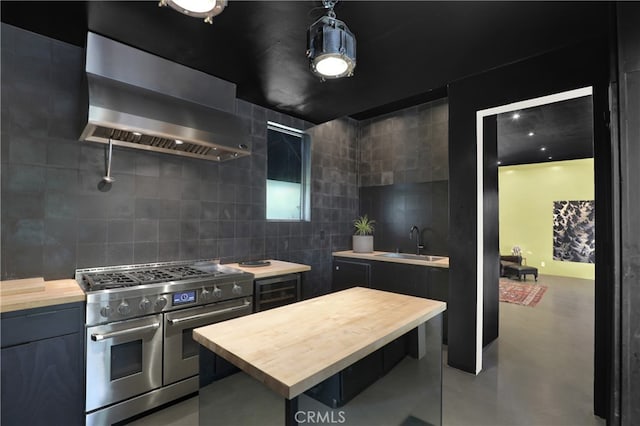 801 E Edgeware Rd, Los Angeles, CA 90026 - kitchen with range with two ovens, wooden counters, wall chimney range hood, a sink, and backsplash