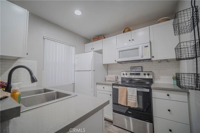 1345 Cabrillo Park Dr Unit J02, Santa Ana, CA 92701 - kitchen with white appliances, a sink, decorative backsplash, white cabinets, and recessed lighting