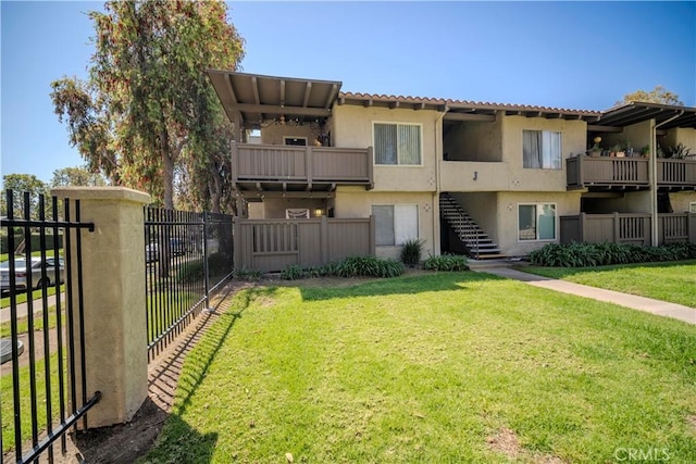 1345 Cabrillo Park Dr Unit J02, Santa Ana, CA 92701 - back of property featuring stucco siding, stairs, and a tiled roof