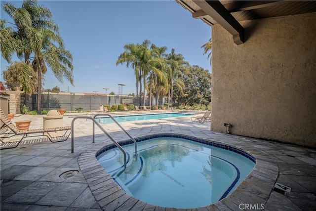 1345 Cabrillo Park Dr Unit J02, Santa Ana, CA 92701 - community pool with a community hot tub, fence, and a patio area