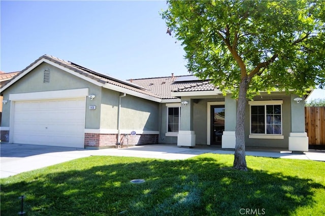 single story home featuring a front yard, roof mounted solar panels, a garage, fence, and stucco siding