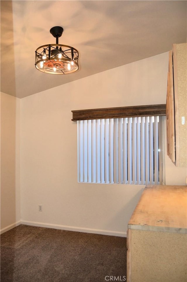 carpeted empty room featuring baseboards