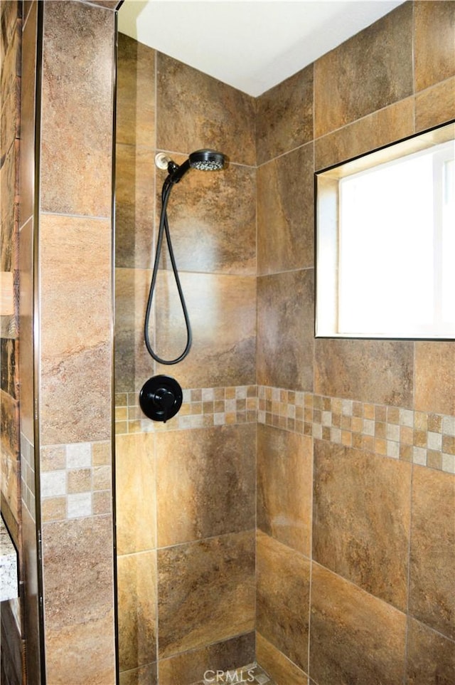 bathroom with tiled shower