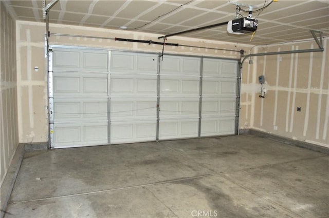 garage with baseboards and a garage door opener