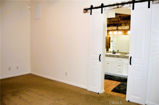 interior space with carpet floors, baseboards, and vanity