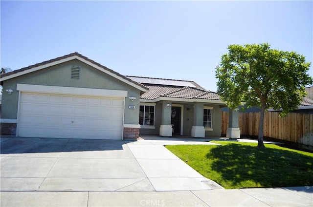 ranch-style home featuring a tiled roof, stucco siding, a front yard, fence, and driveway