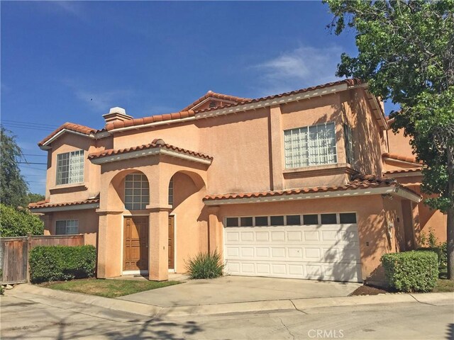 907 W Arrow, Claremont, CA 91711 - mediterranean / spanish house featuring a chimney, driveway, a tiled roof, an attached garage, and fence