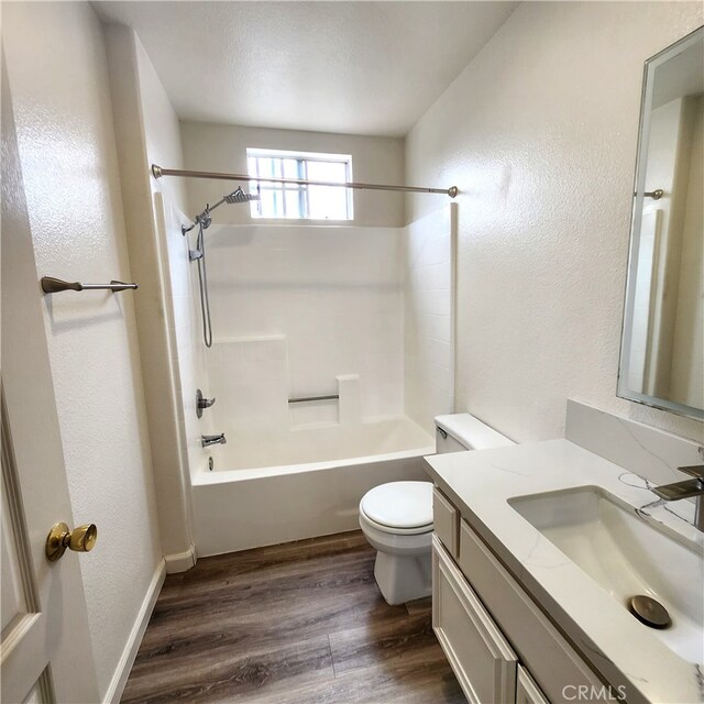 907 W Arrow, Claremont, CA 91711 - bathroom featuring toilet, wood finished floors, a textured wall, vanity, and tub / shower combination