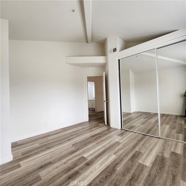 907 W Arrow, Claremont, CA 91711 - unfurnished bedroom featuring lofted ceiling with beams, baseboards, wood finished floors, and a closet