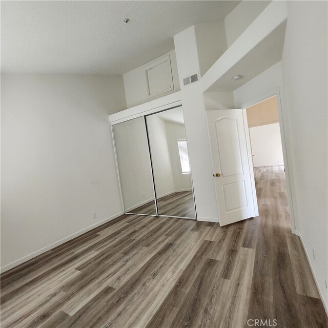 907 W Arrow, Claremont, CA 91711 - unfurnished bedroom with baseboards, wood finished floors, visible vents, and a closet