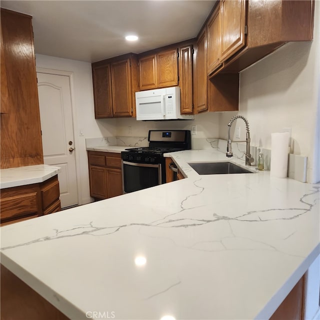 907 W Arrow, Claremont, CA 91711 - kitchen featuring brown cabinets, stainless steel gas range, a sink, and white microwave