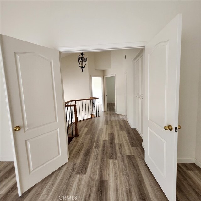 907 W Arrow, Claremont, CA 91711 - corridor featuring wood finished floors, baseboards, and an upstairs landing