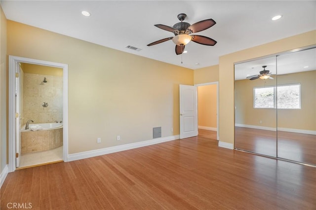 27732 N Bay Rd, Lake Arrowhead, CA 92352 - unfurnished bedroom featuring wood finished floors, baseboards, a closet, ensuite bath, and recessed lighting