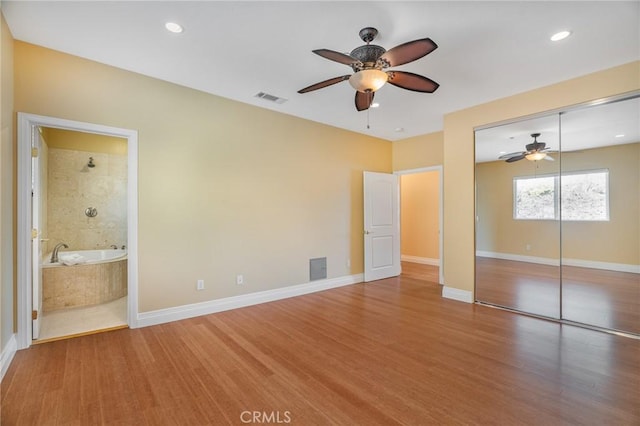 27732 N Bay Rd, Lake Arrowhead, CA 92352 - unfurnished bedroom featuring wood finished floors, a closet, connected bathroom, a ceiling fan, and recessed lighting