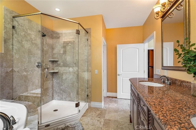 bathroom featuring vanity, baseboards, and a shower stall