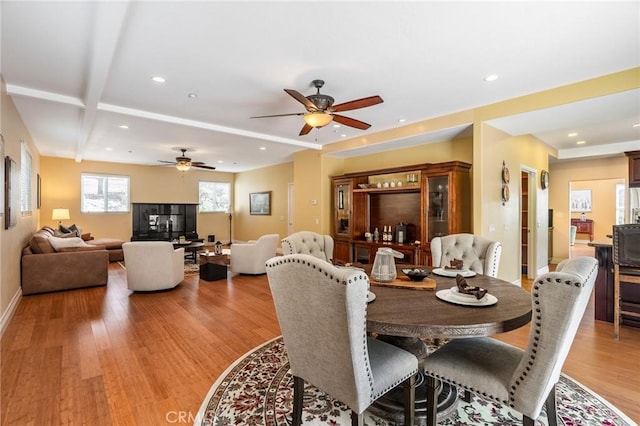 dining room with baseboards, light wood-style flooring, a ceiling fan, and recessed lighting