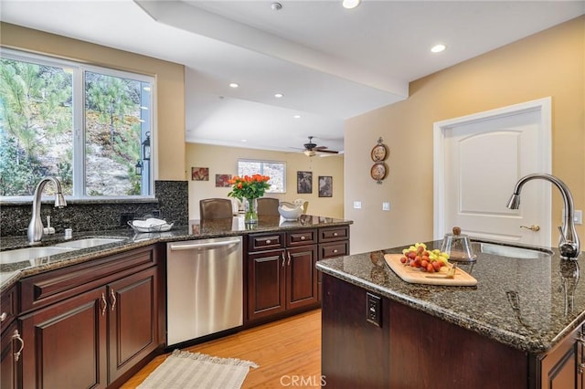 27732 N Bay Rd, Lake Arrowhead, CA 92352 - kitchen with stainless steel dishwasher, a sink, light wood finished floors, dark stone counters, and recessed lighting