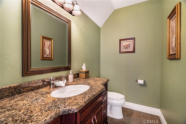half bathroom with toilet, baseboards, tile patterned flooring, vanity, and vaulted ceiling