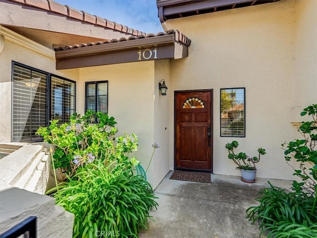 101 Searidge Ct, Pismo Beach, CA 93449 - doorway to property featuring stucco siding and a tiled roof