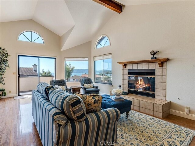 101 Searidge Ct, Pismo Beach, CA 93449 - living room featuring plenty of natural light, wood-type flooring, a tile fireplace, beamed ceiling, and high vaulted ceiling