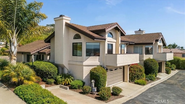 101 Searidge Ct, Pismo Beach, CA 93449 - view of front of property with a chimney, a garage, stucco siding, and a tiled roof