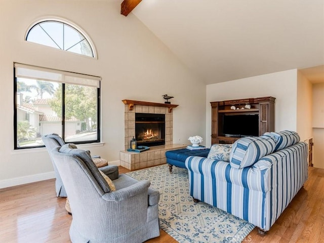 101 Searidge Ct, Pismo Beach, CA 93449 - living room with high vaulted ceiling, light wood-style flooring, a tile fireplace, plenty of natural light, and beam ceiling