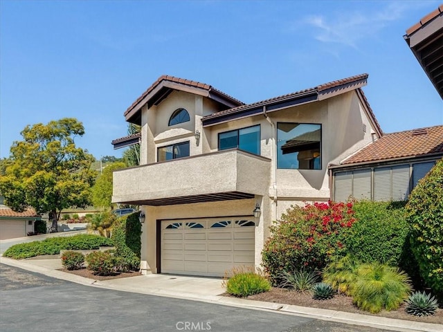 101 Searidge Ct, Pismo Beach, CA 93449 - view of front of house featuring a garage, stucco siding, a balcony, and concrete driveway