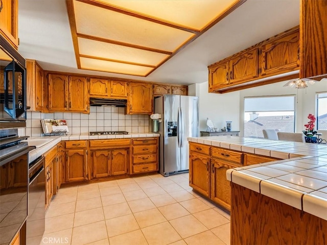 101 Searidge Ct, Pismo Beach, CA 93449 - kitchen featuring stainless steel refrigerator with ice dispenser, brown cabinetry, and under cabinet range hood