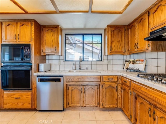 101 Searidge Ct, Pismo Beach, CA 93449 - kitchen with black appliances, brown cabinetry, decorative backsplash, and light tile patterned floors