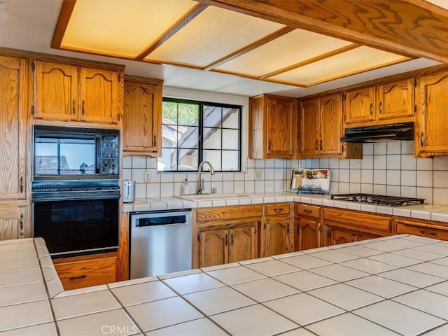 101 Searidge Ct, Pismo Beach, CA 93449 - kitchen with black appliances, under cabinet range hood, decorative backsplash, and brown cabinets