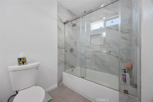 full bathroom featuring tile patterned flooring, baseboards, combined bath / shower with glass door, and toilet