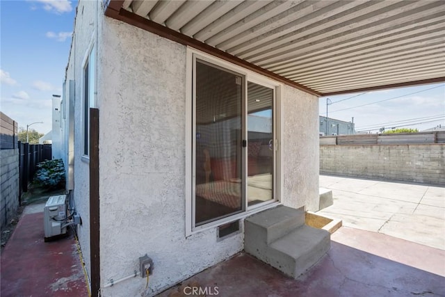 view of patio featuring fence, central AC unit, and entry steps