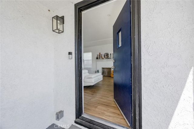 doorway to property featuring stucco siding