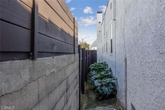 view of property exterior featuring fence and stucco siding
