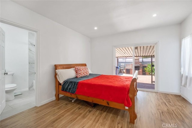 bedroom with access to outside, light wood-style floors, and multiple windows