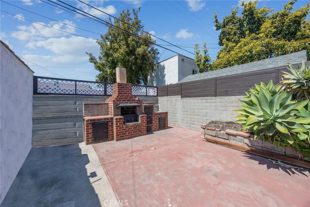 view of patio with a fenced backyard and an outdoor brick fireplace