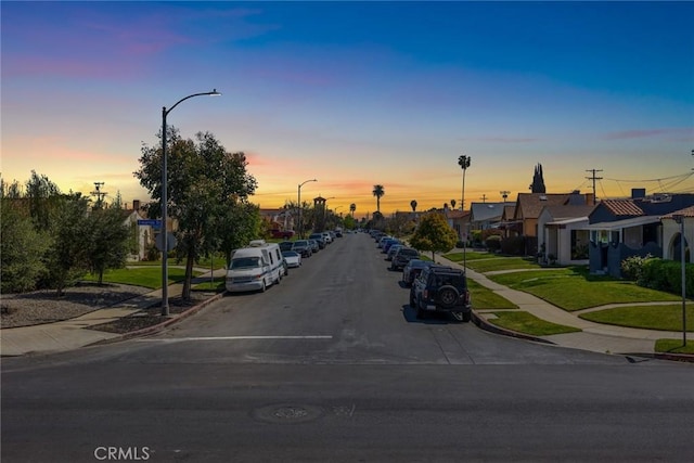 view of street with street lighting, sidewalks, and curbs