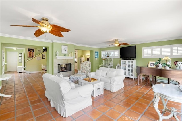living room featuring a multi sided fireplace, ornamental molding, and ceiling fan
